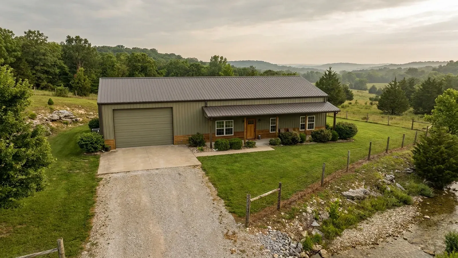 A barndominium with a tall, deep RV garage bay attached to the residence under one continuous roof.