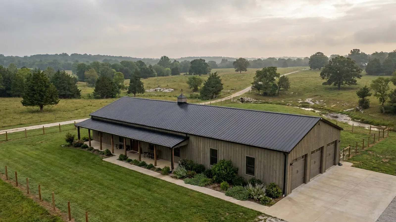 A completed single-story barndominium with a long, low roofline and no upper-level windows.